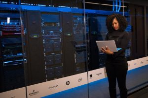 Woman in server room with electrical equipment